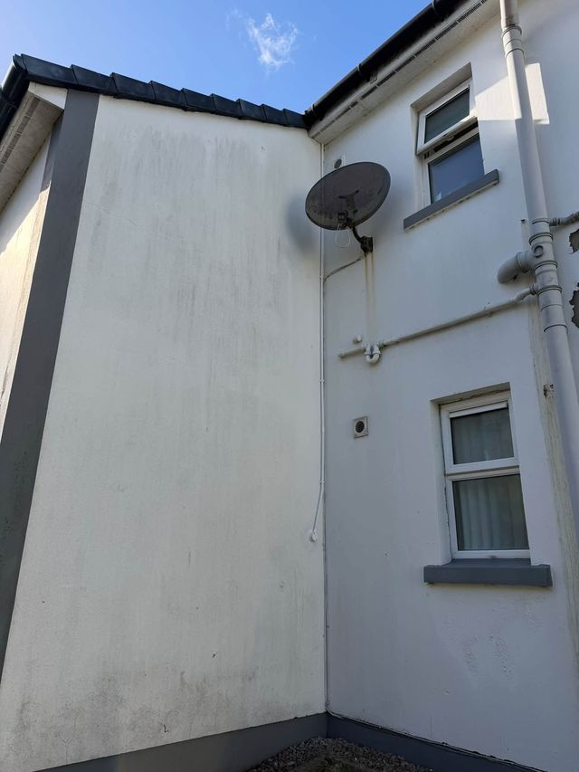 Housing block exterior with the communal satellite dish and conduit runs