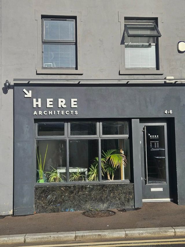 HERE Architects shop front in Ballymoney with the CCTV camera above the sign